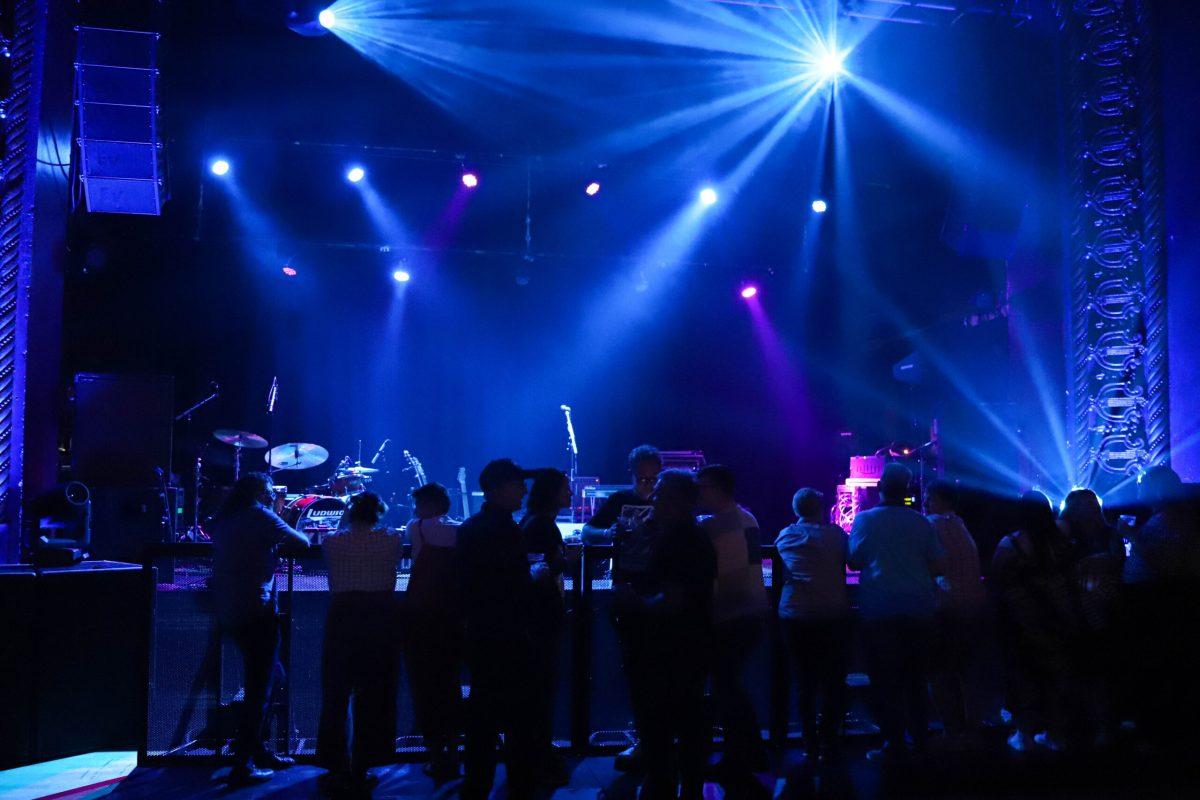 Concertgoers standing in front of the stage.