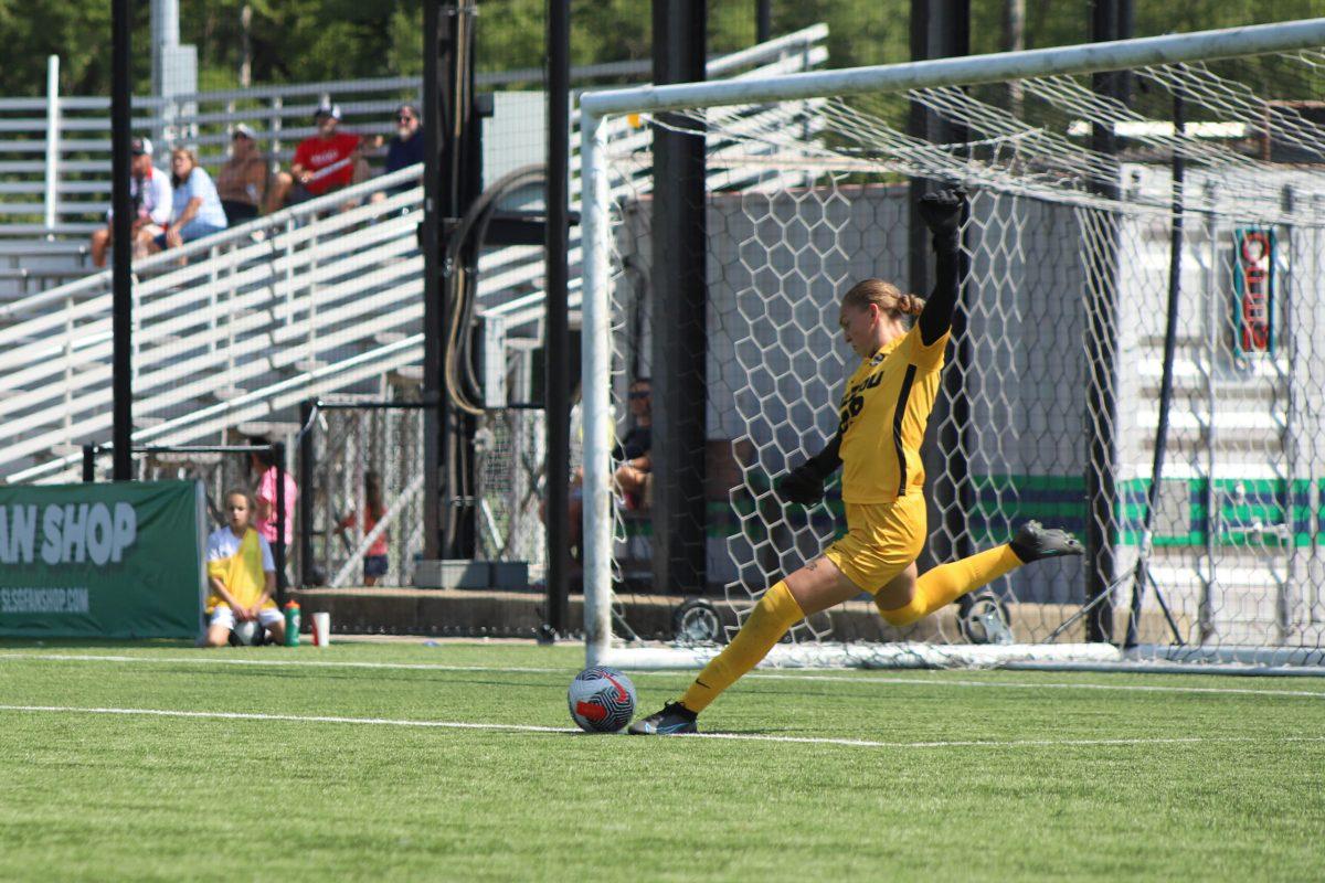 Goalkeeper preparing to kick the ball away.