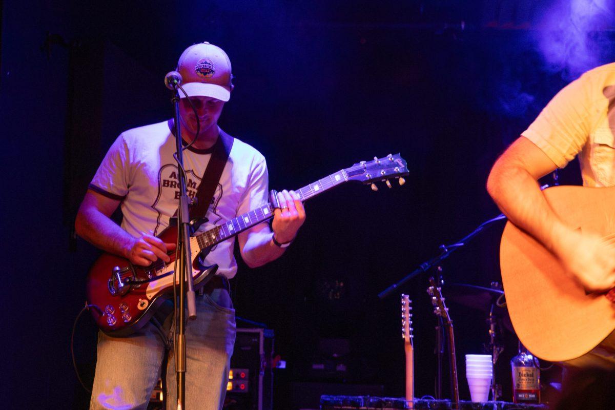 Willard Logan plays the electric guitar with Boy Named Banjo during their concert.