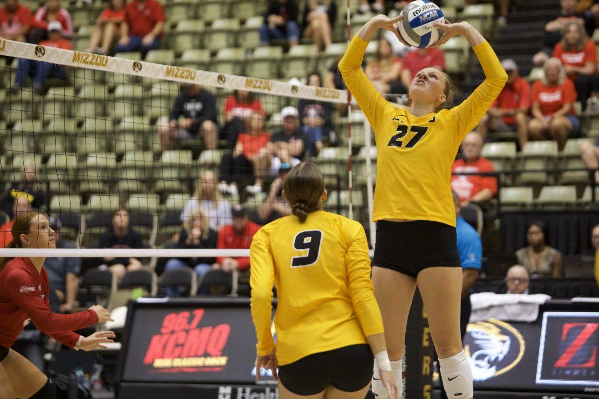 A volleyball player sets the ball.