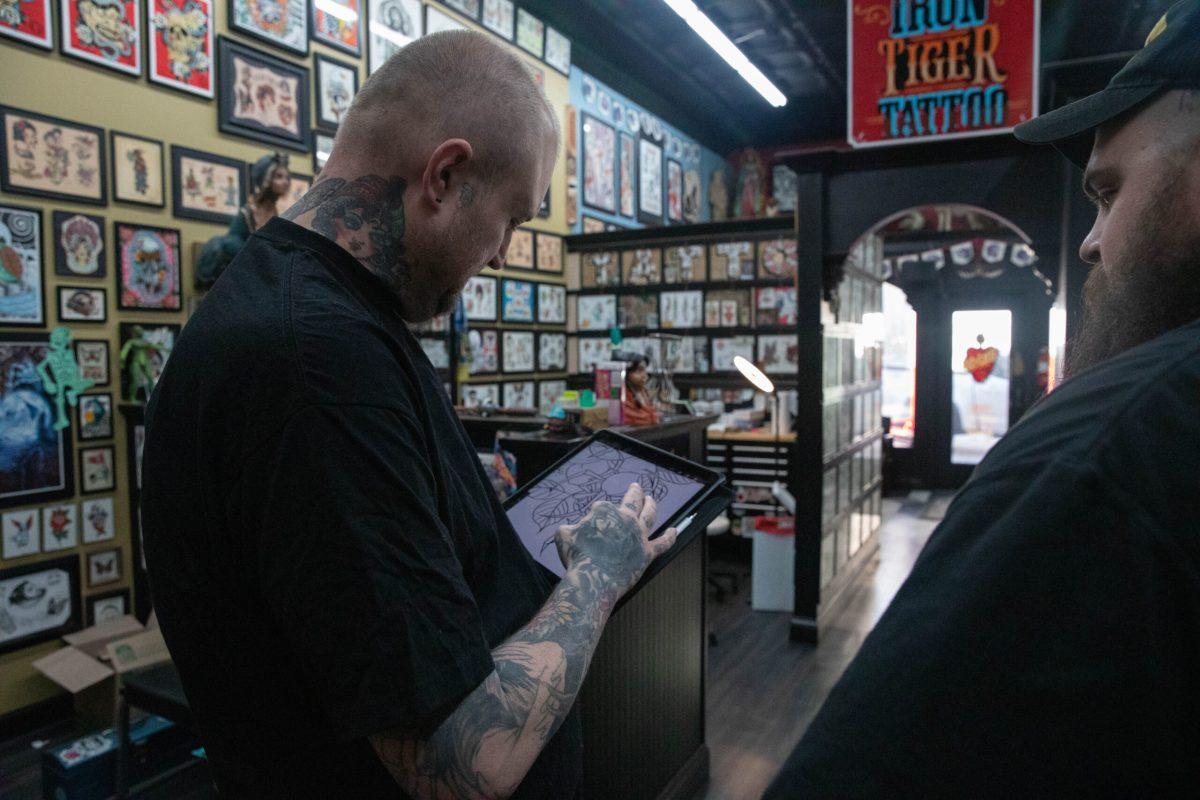 Owner Gabe Garcia double checks his artwork on his iPad. 