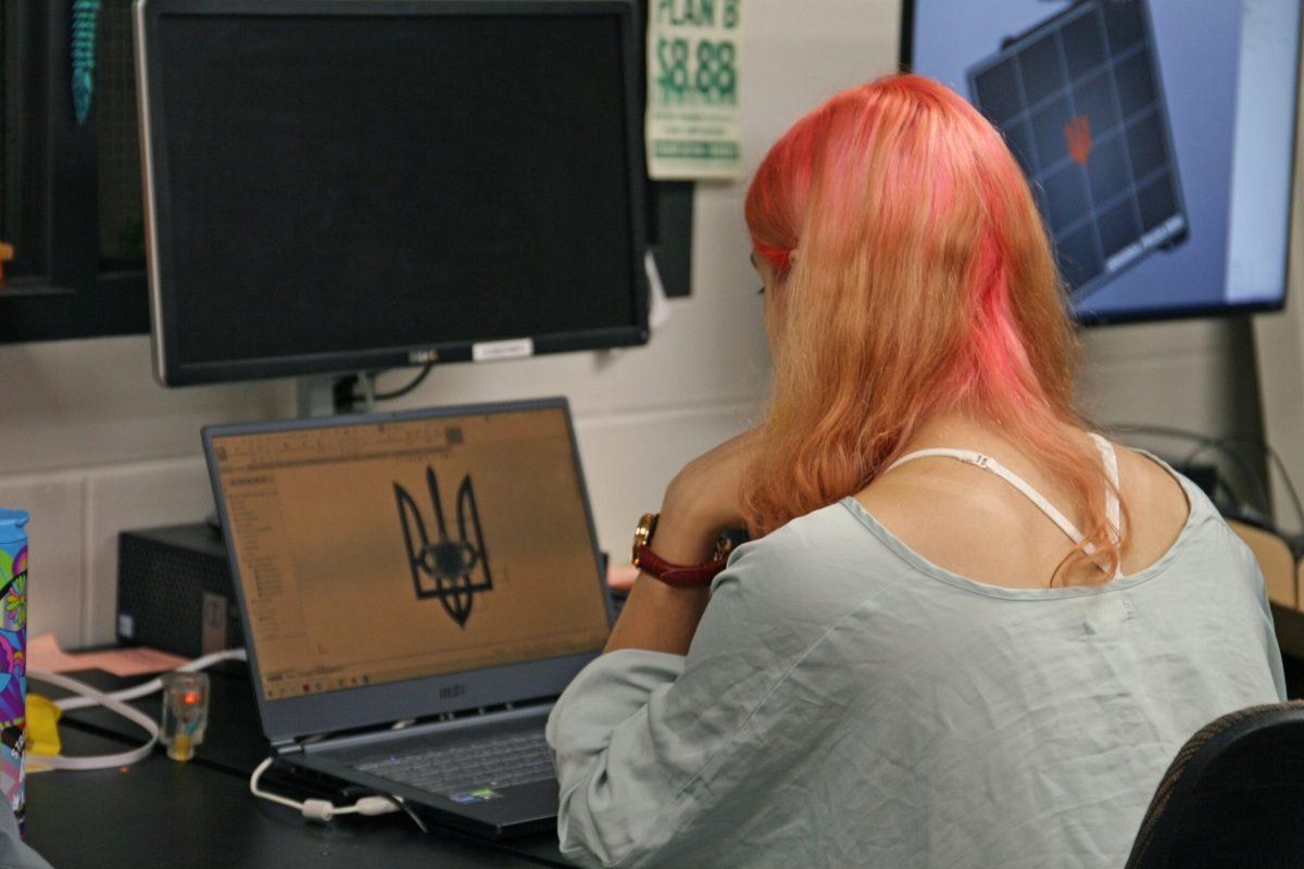 Alina Rohulia looks at a 3D printing design of a trident and star on her computer in Lafferre Hall’s 3D printing lab.