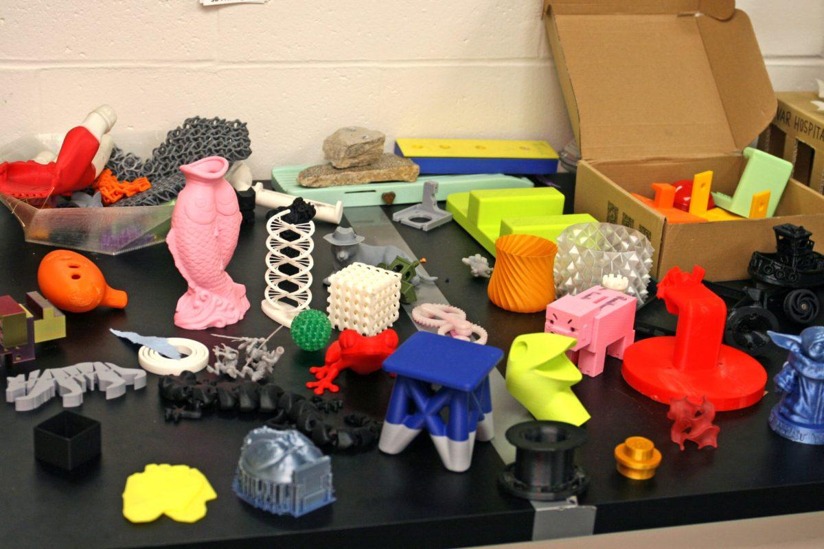 A variety of 3D printing designs in many different colors is seen on a table in the 3D printing lab of Lafferre Hall.