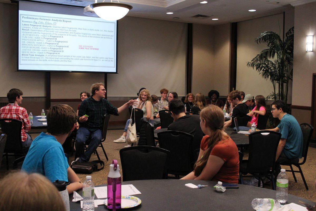 The photo shows a wide shot of the room as people are talking to one another at the end of the event.