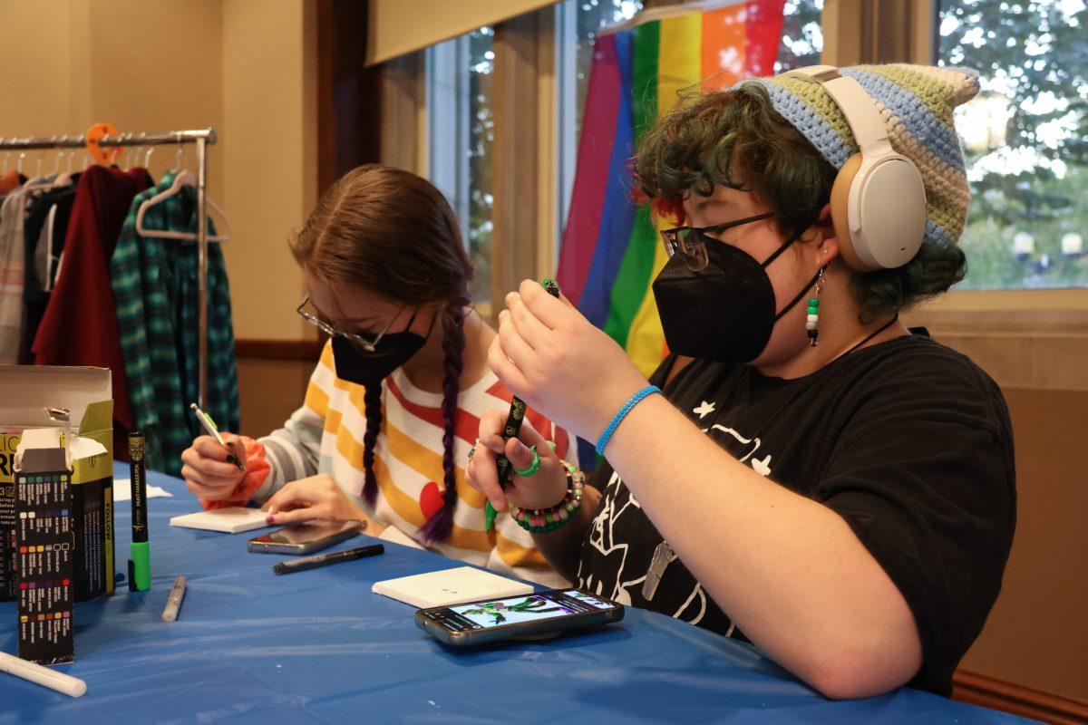 A student coloring a mini canvas.