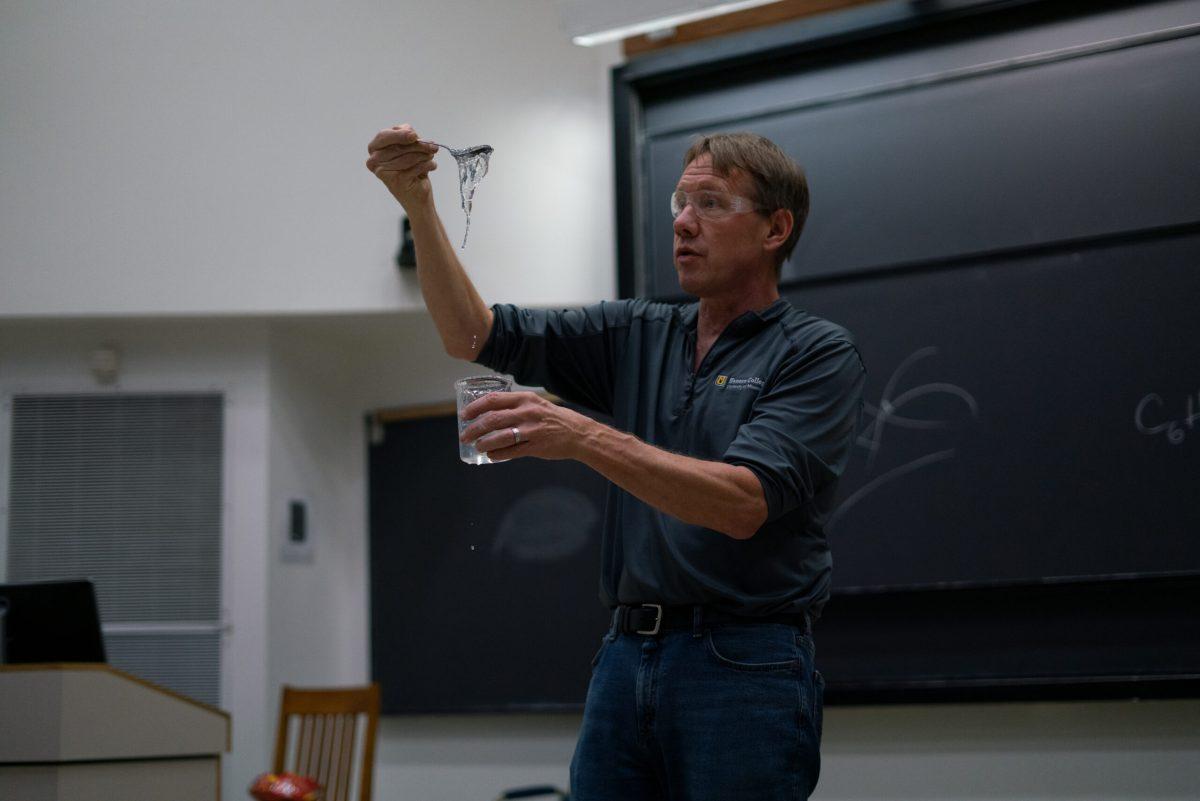 Dr. Steven Keller holds up slime to show students