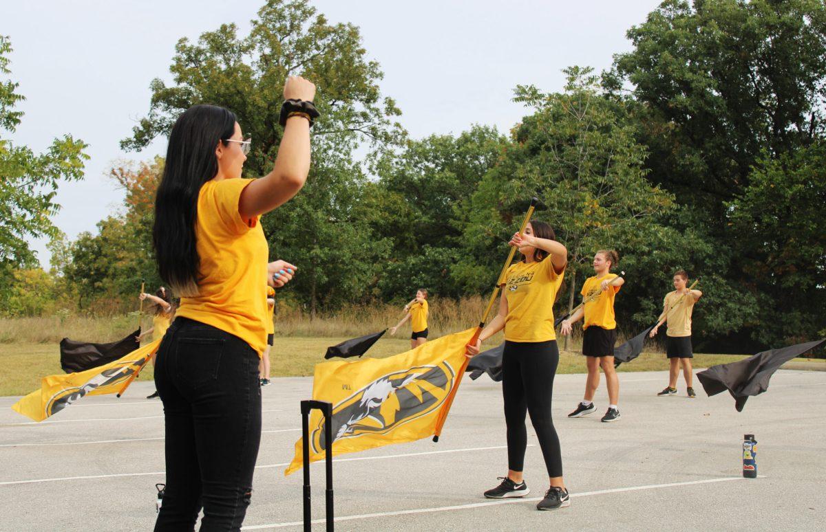 Color Guard director Hannah Sinek critiques the team's work on their flag choreography.