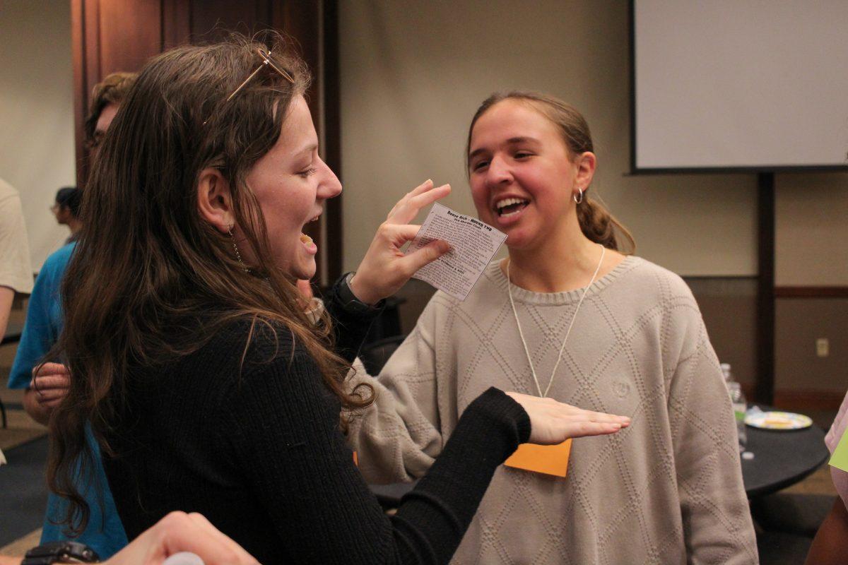 The photo shows two people laughing at each other.