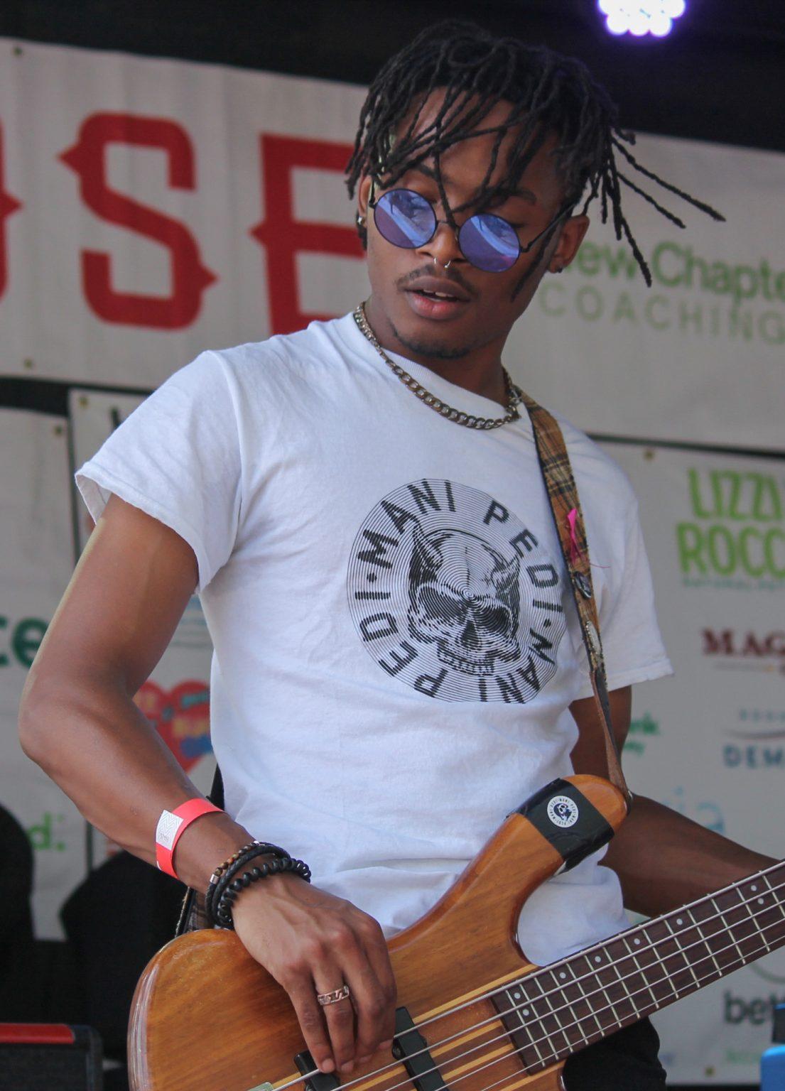 Guitarist plays guitar on stage.