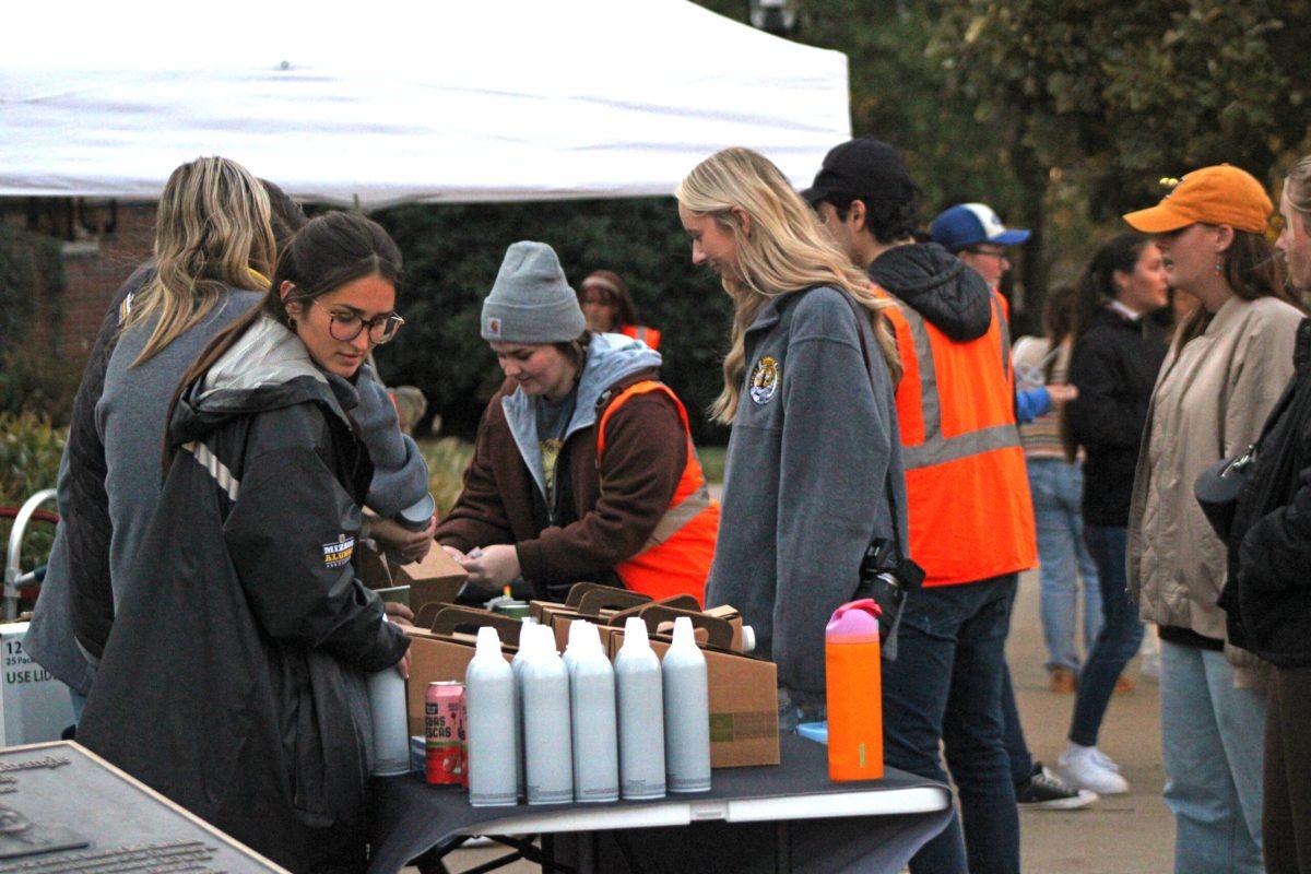 Students in line waiting to get hot chocolate as they are bundled up in the cold weather.
