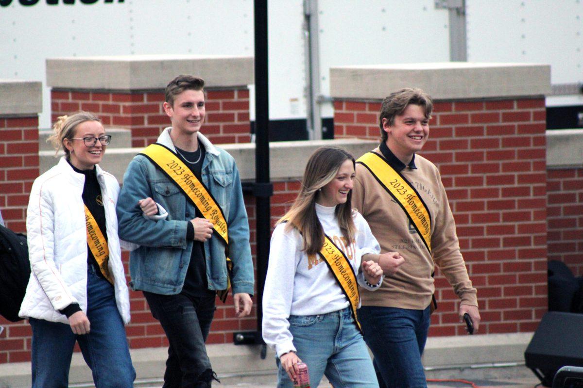 A group of Homecoming Royalty practice their walk on the stage at Plaza Traditions.
