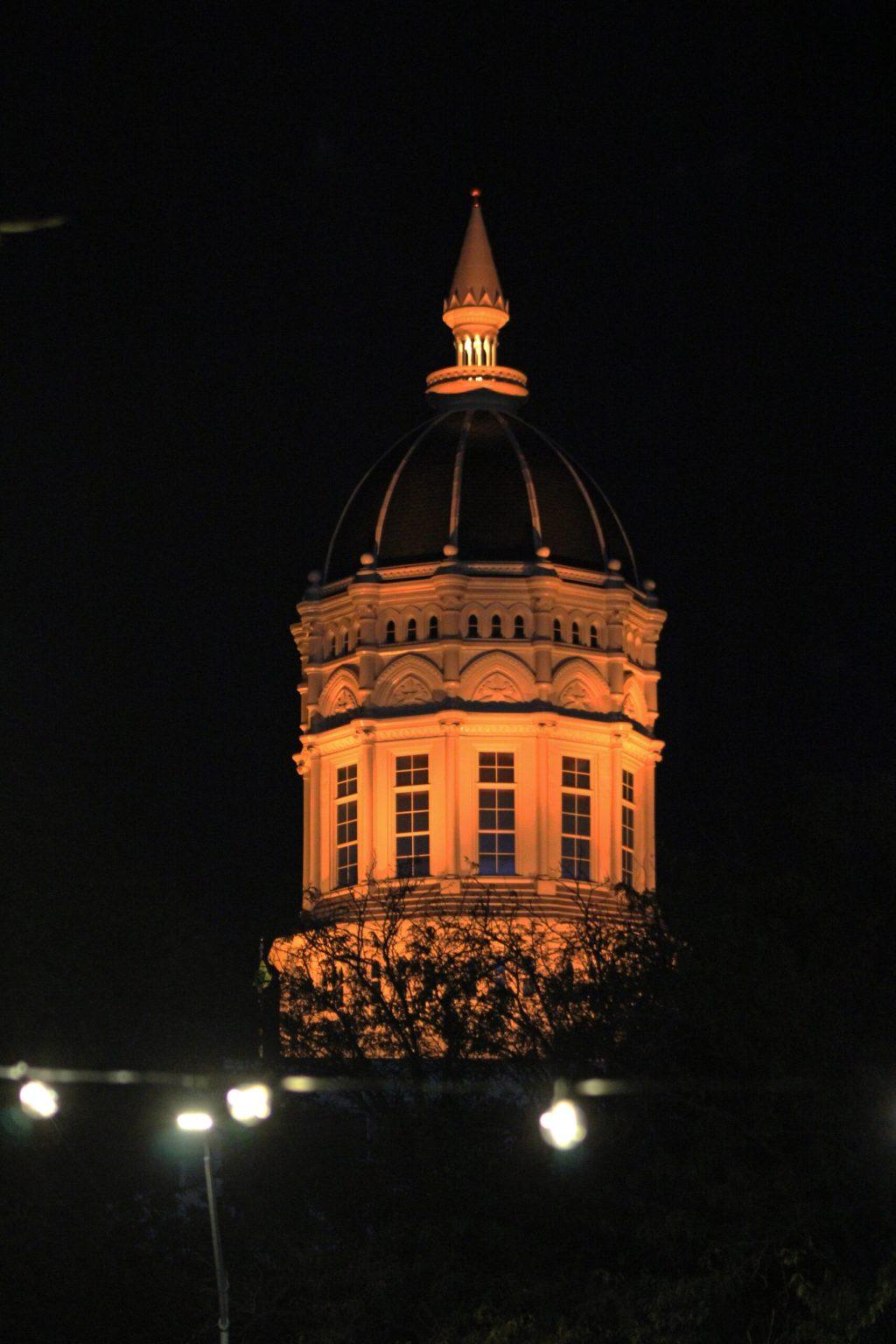 Jesse Hall Dome glowing gold in the dark night sky.