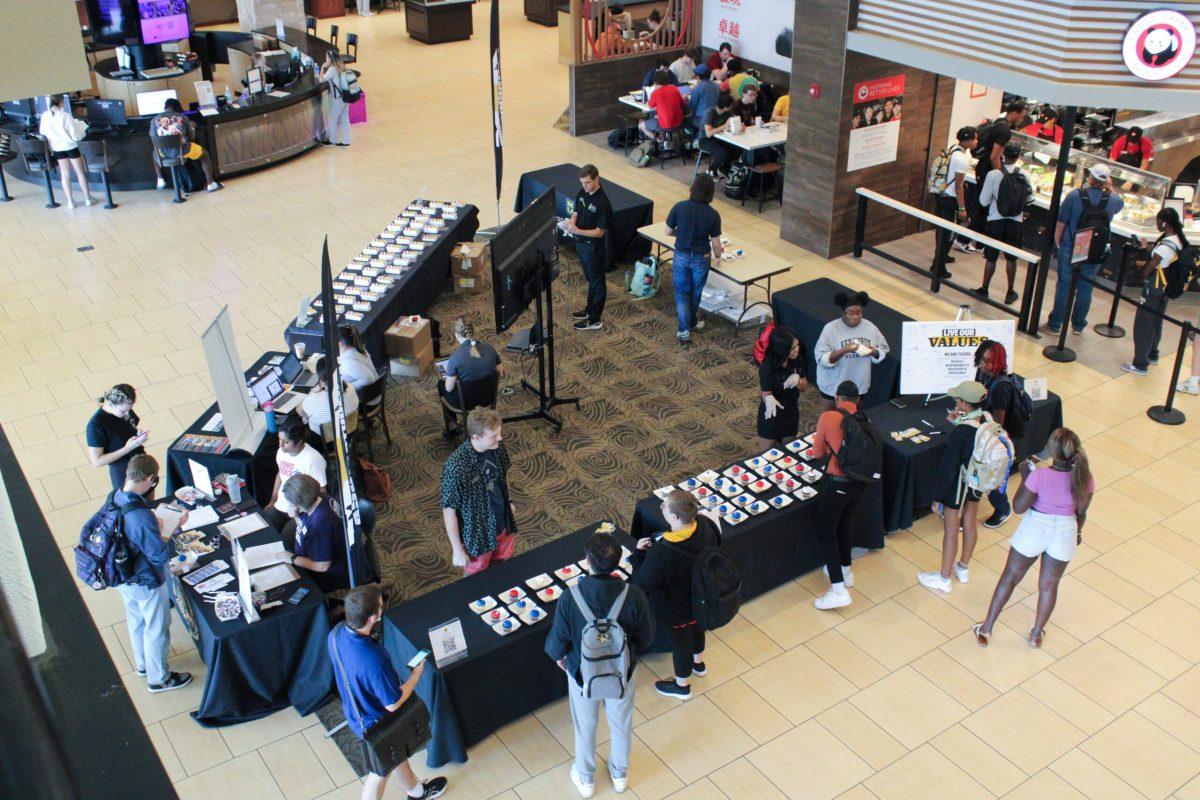 An overview of all of the booths in the Student Center for Constitution Day. The two front tables are covered with red and blue iced cupcakes.