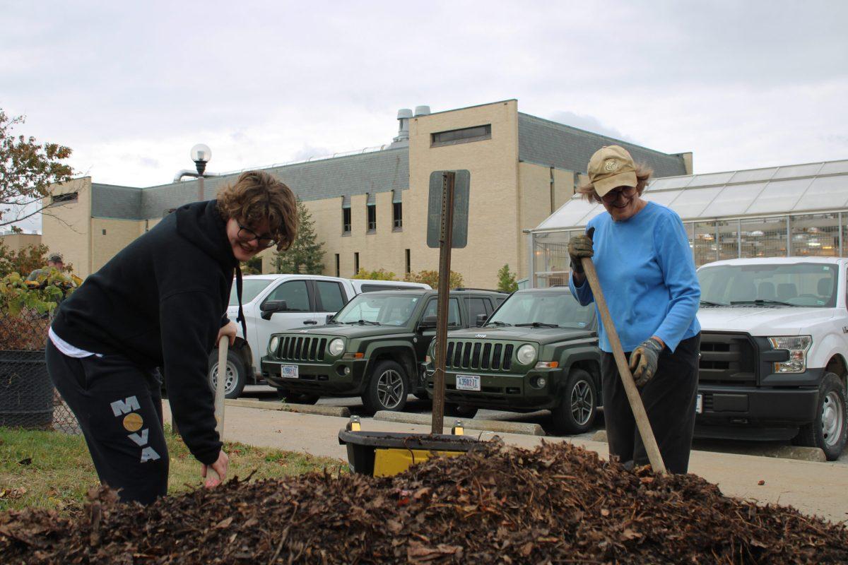 Adrian Dunivan and Lisa Licklider shovel mulch to bring to the garden.
