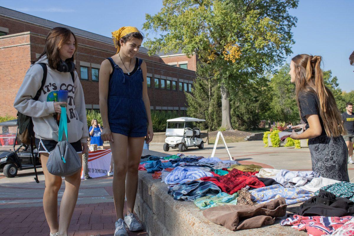 Sophomore India Williams (middle) talks to fellow members about the success of the fundraiser so far. 