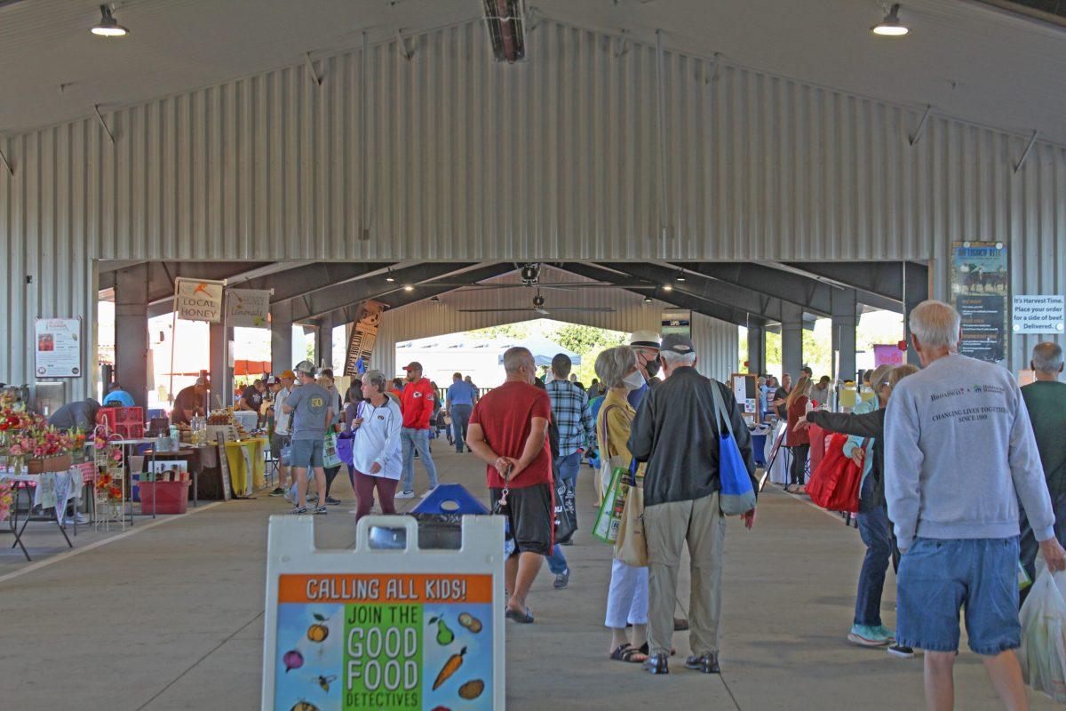 Customers mingle at the Farmers Market.

