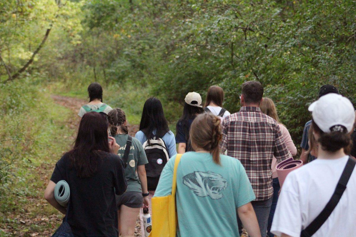 A group of people walk on a trail.

