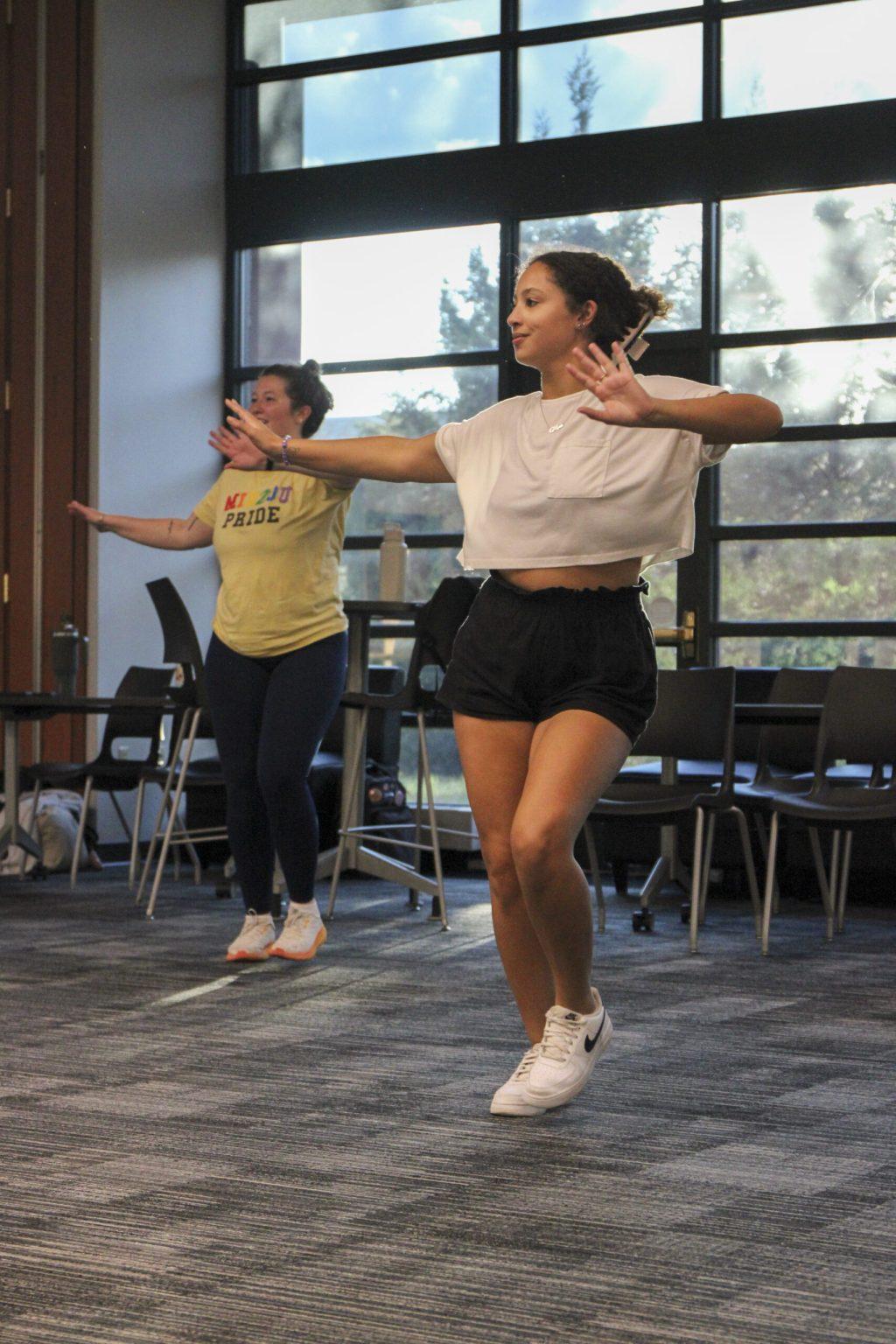 Student support specialist Sophia Hood and junior Mya Franklin dance at the Gaines/Oldham Black Culture Center in Columbia, Missouri.
