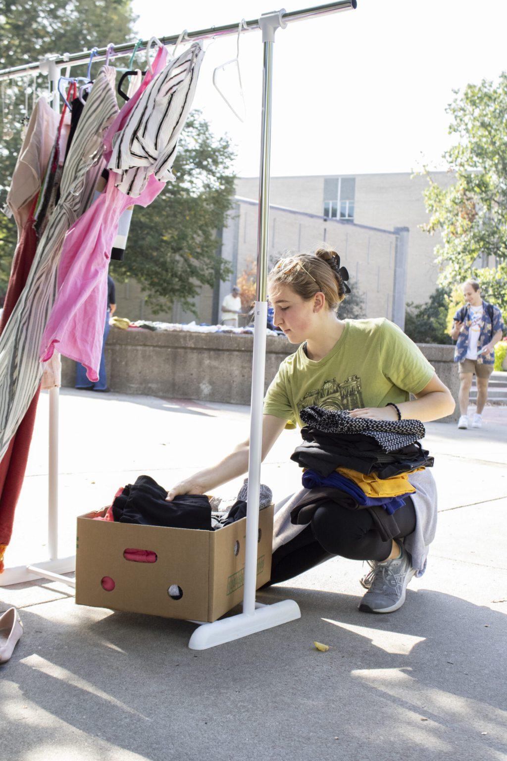 Freshman Rachel Trotsky organizes clothes at Speakers Circle in Columbia, Mo.