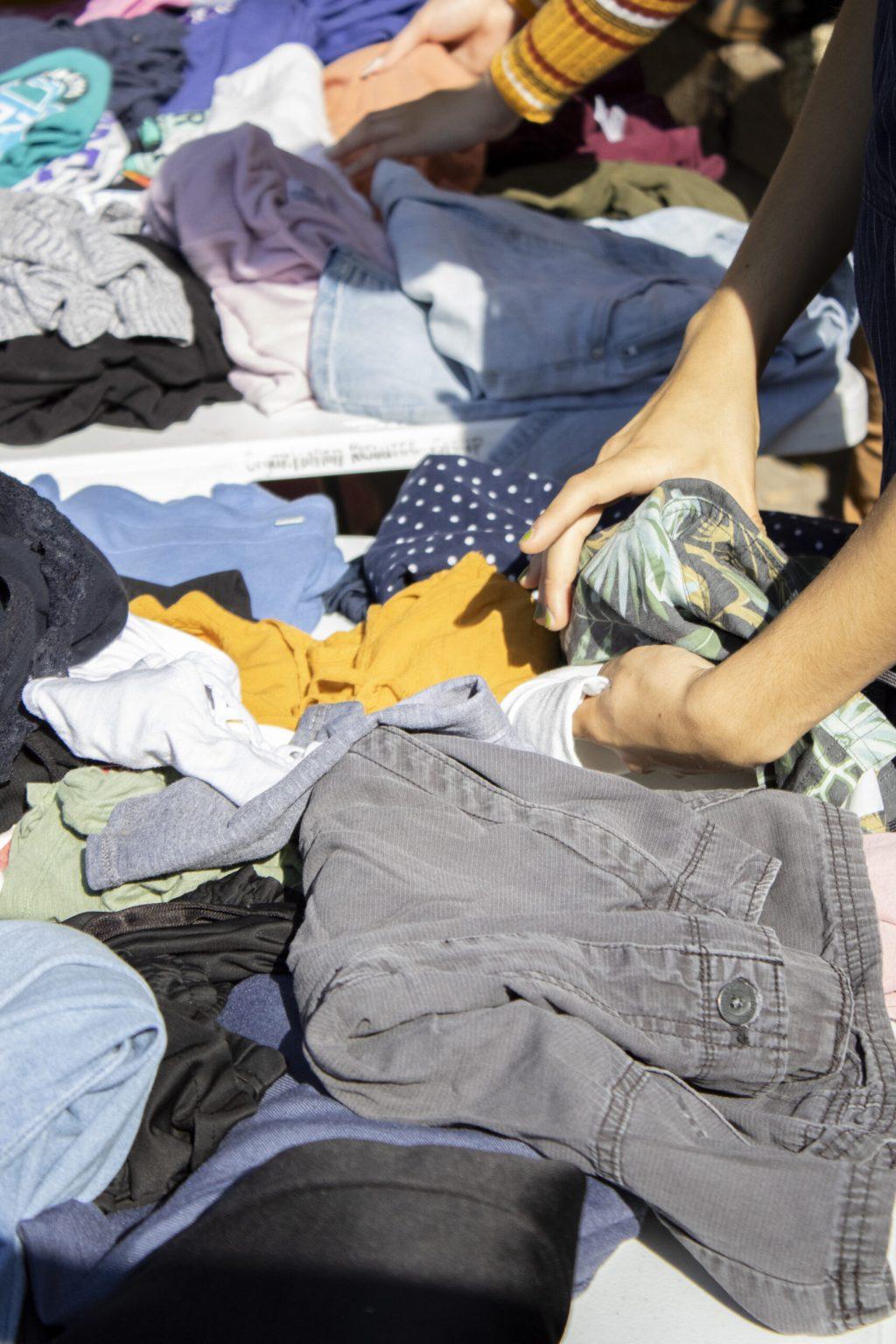 Students search through clothes at Speakers Circle in Columbia, Mo.