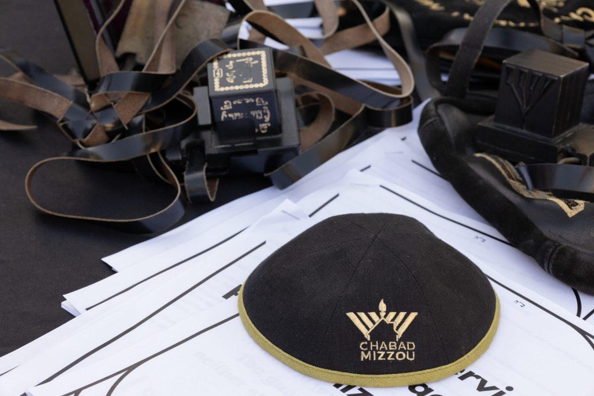 A yarmulke reading “Chabad Mizzou” sits next to tefillin and prayer booklets.
