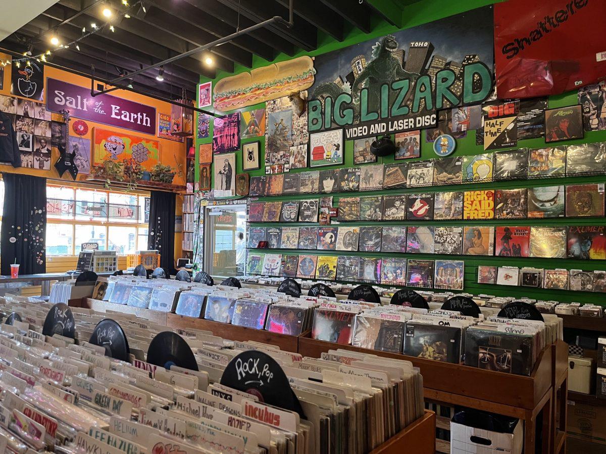 The first floor of Hitt Records has boxes of vinyl and records hung on the walls.