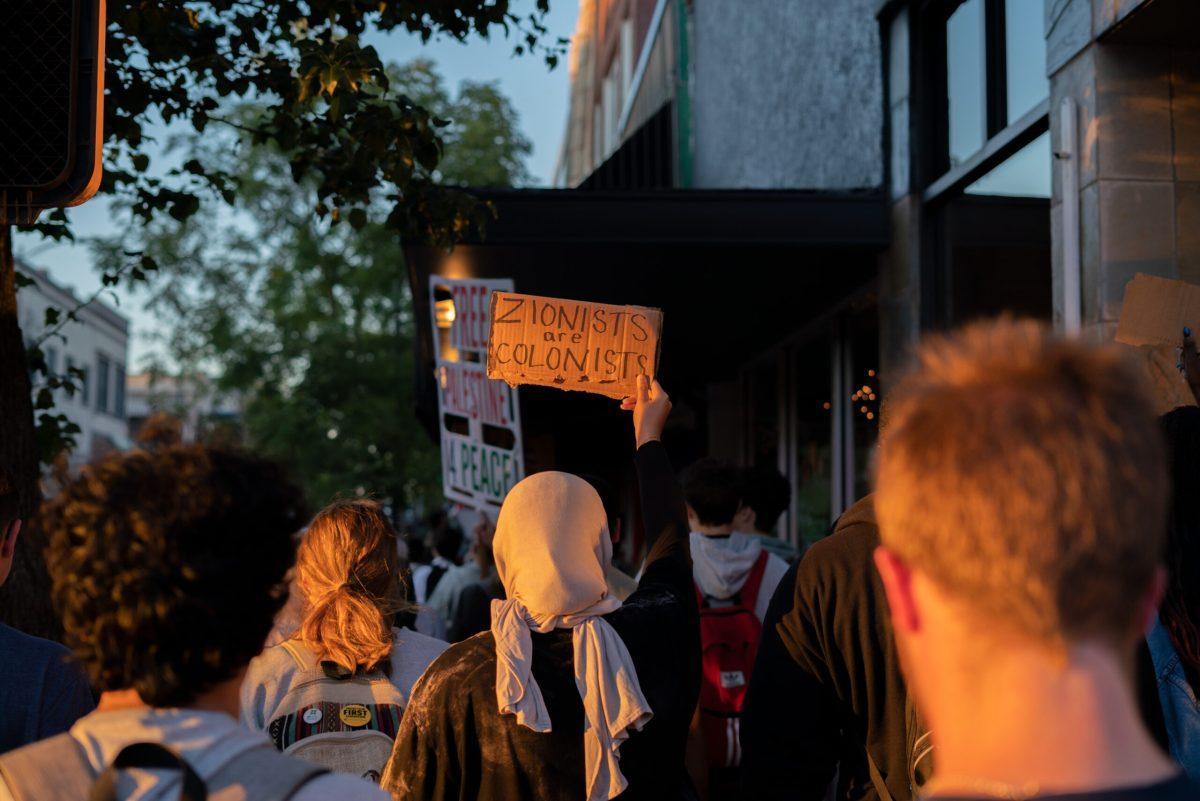 Protester holds up cardboard sign