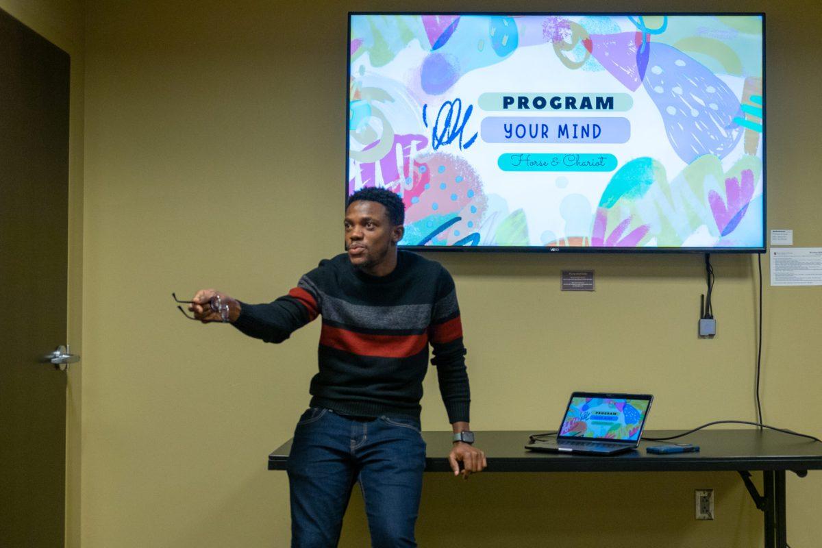  A man teaches in front of a screen.
