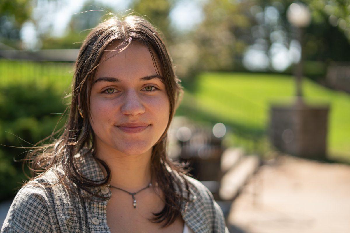 MU student smiles for a portrait outside.
