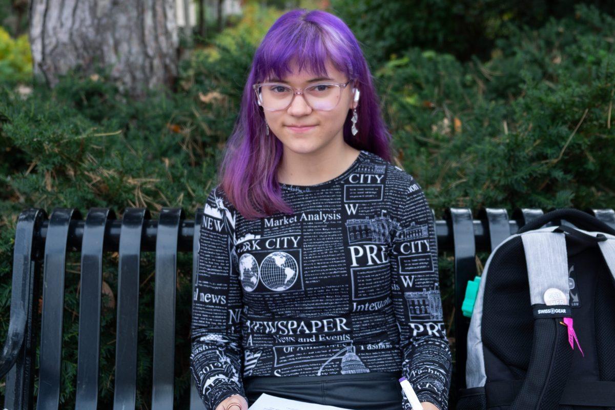 An MU student smiles at the camera.