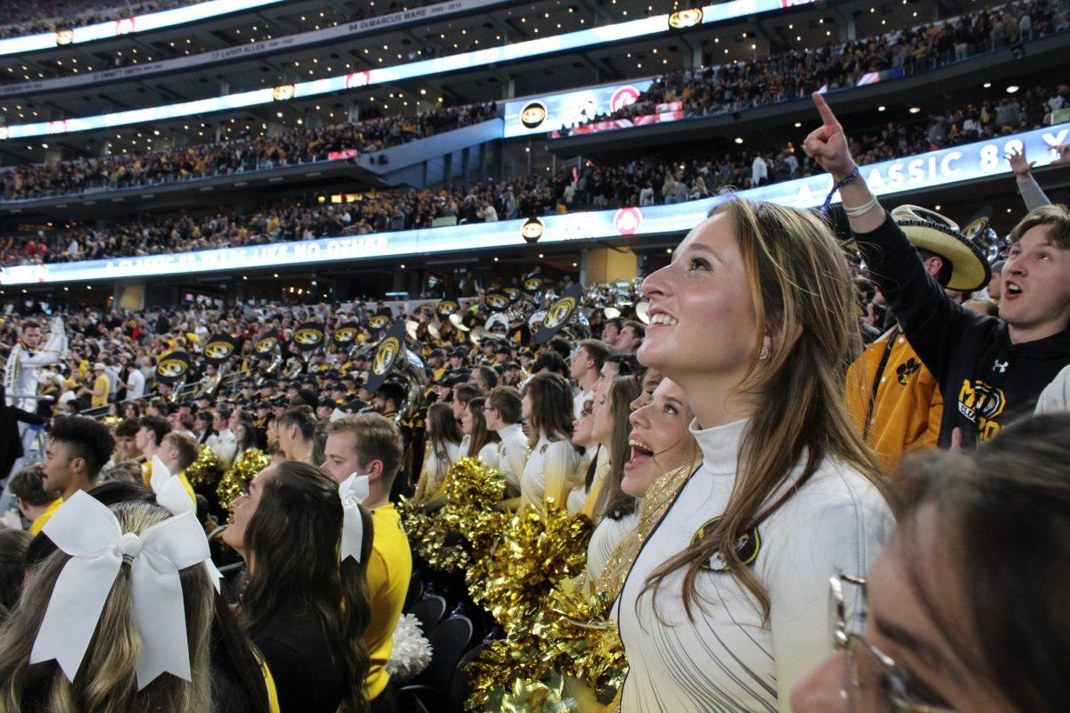 A girl smiles at AT&T Stadium.