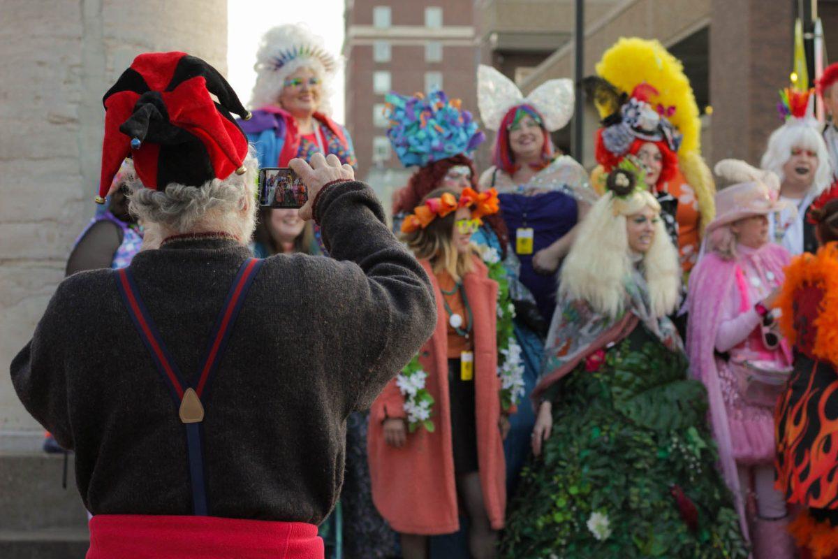 Man takes picture of Q Queens.
