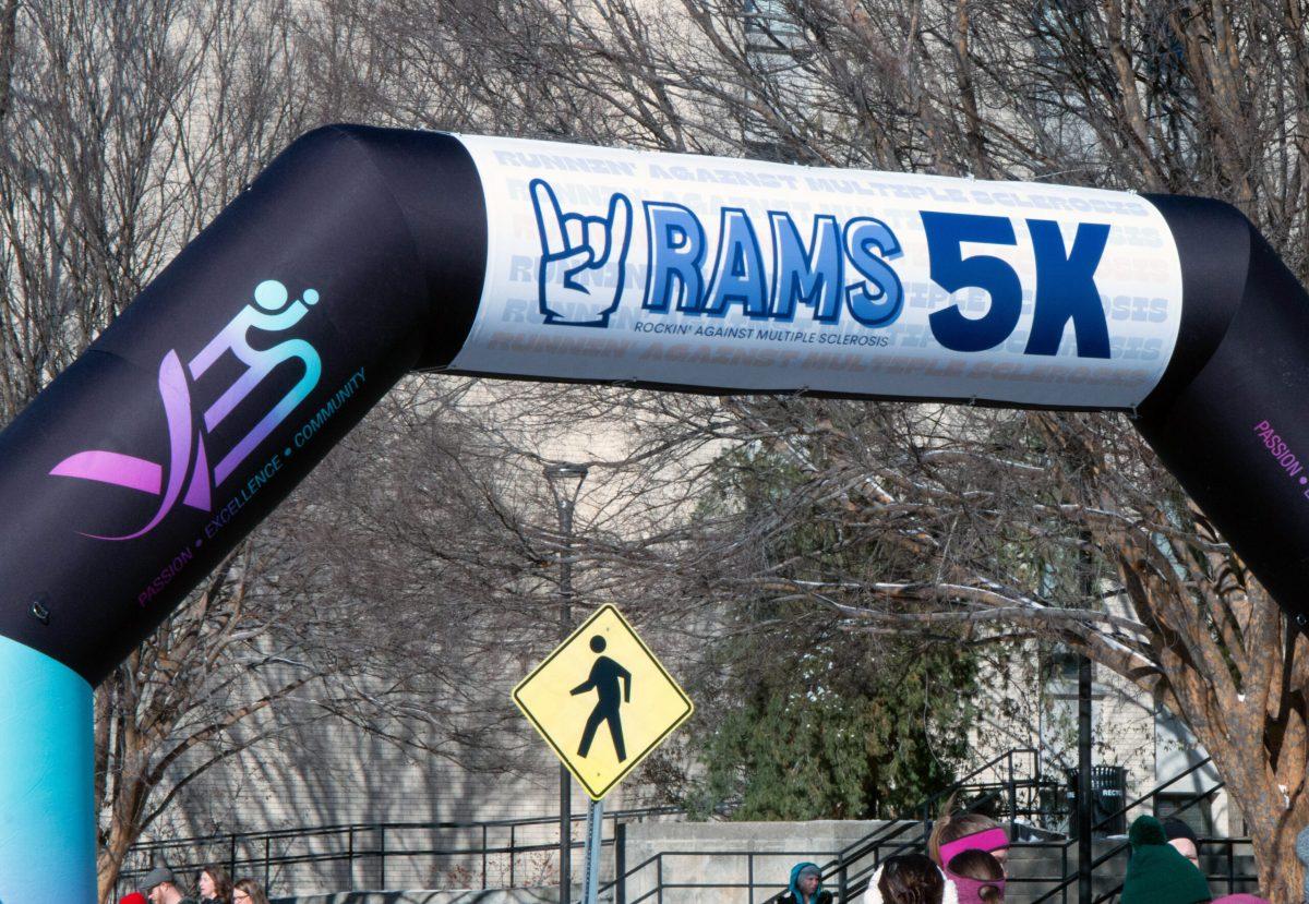 A blown-up arch at the start and finish line of the 5K. The logo of Mizzou RAMS is shown, along with a graphic with “Passion, Excellence and Community” written on the side.