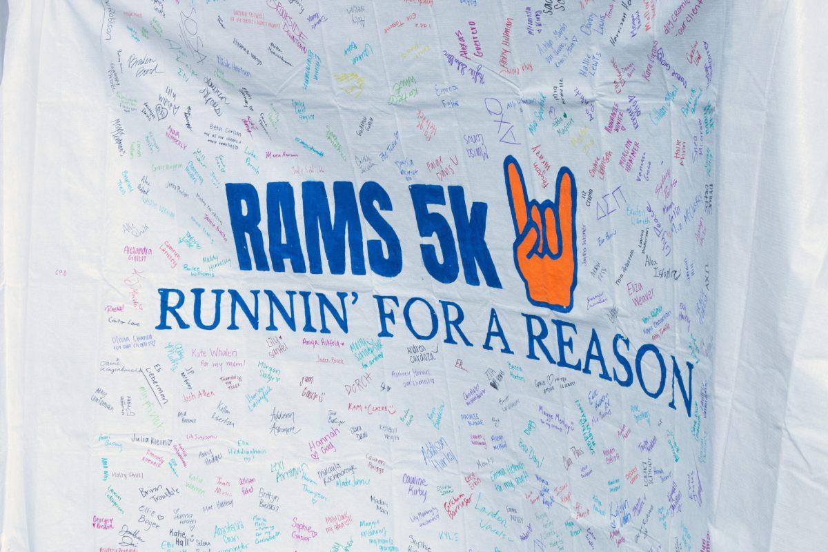 The “RAMS 5K Runnin’ for a Reason” sign hanging from the Student Center outdoor columns. Signatures are visible all over the sign in all different colors and directions.