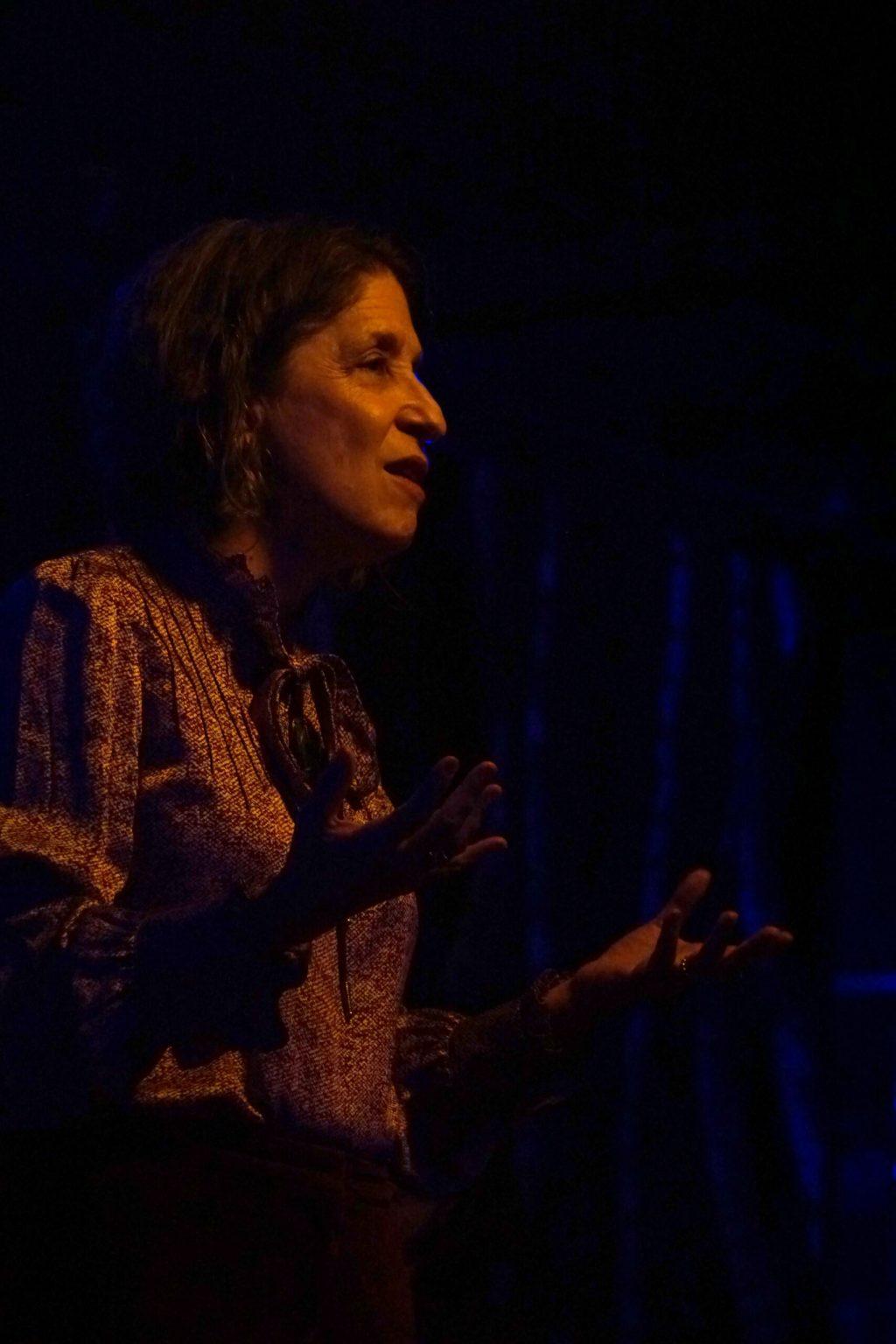 A woman speaks to a crowd. 