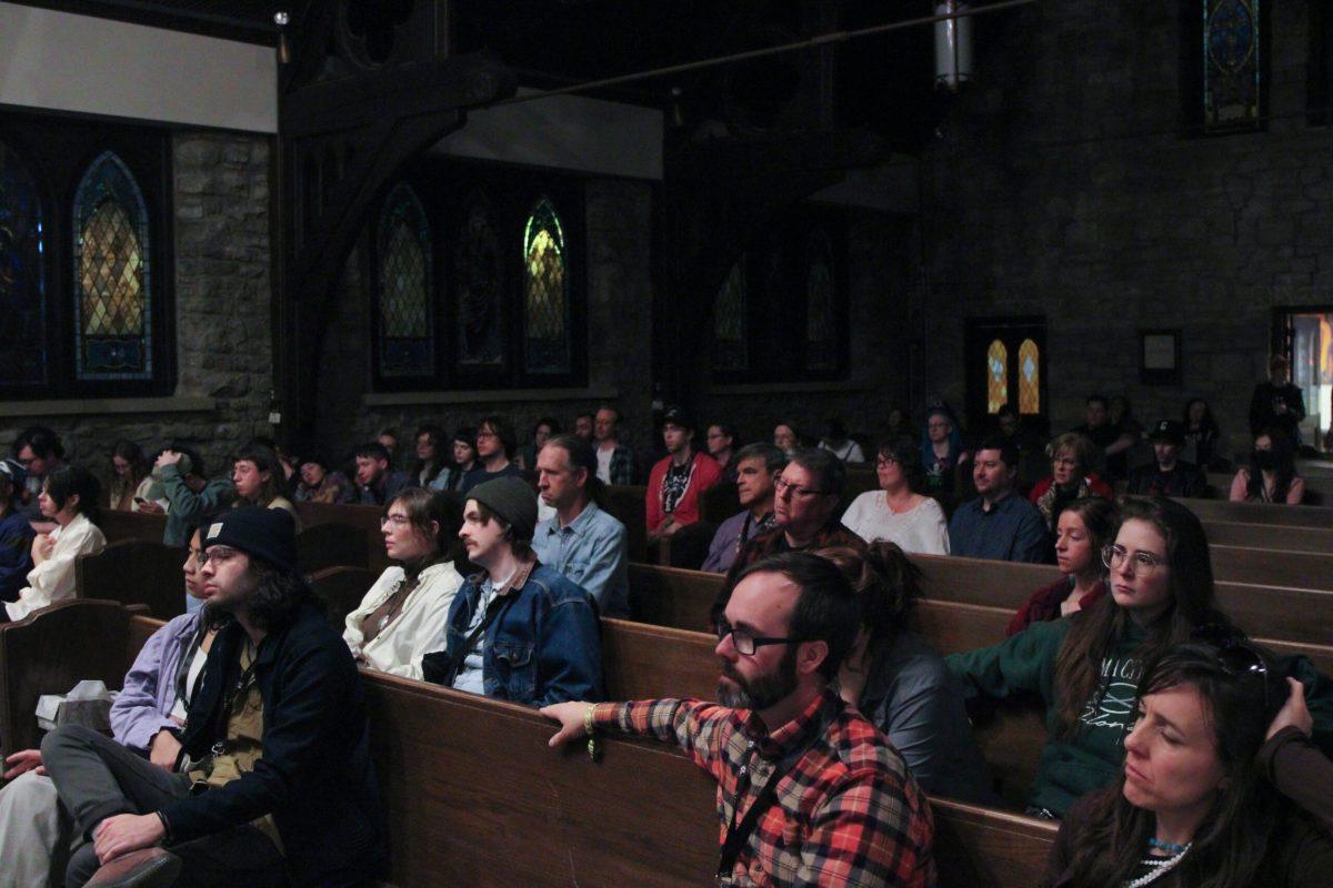 The audience is shown sitting in the church pews watching the musicians and meditating with the music.