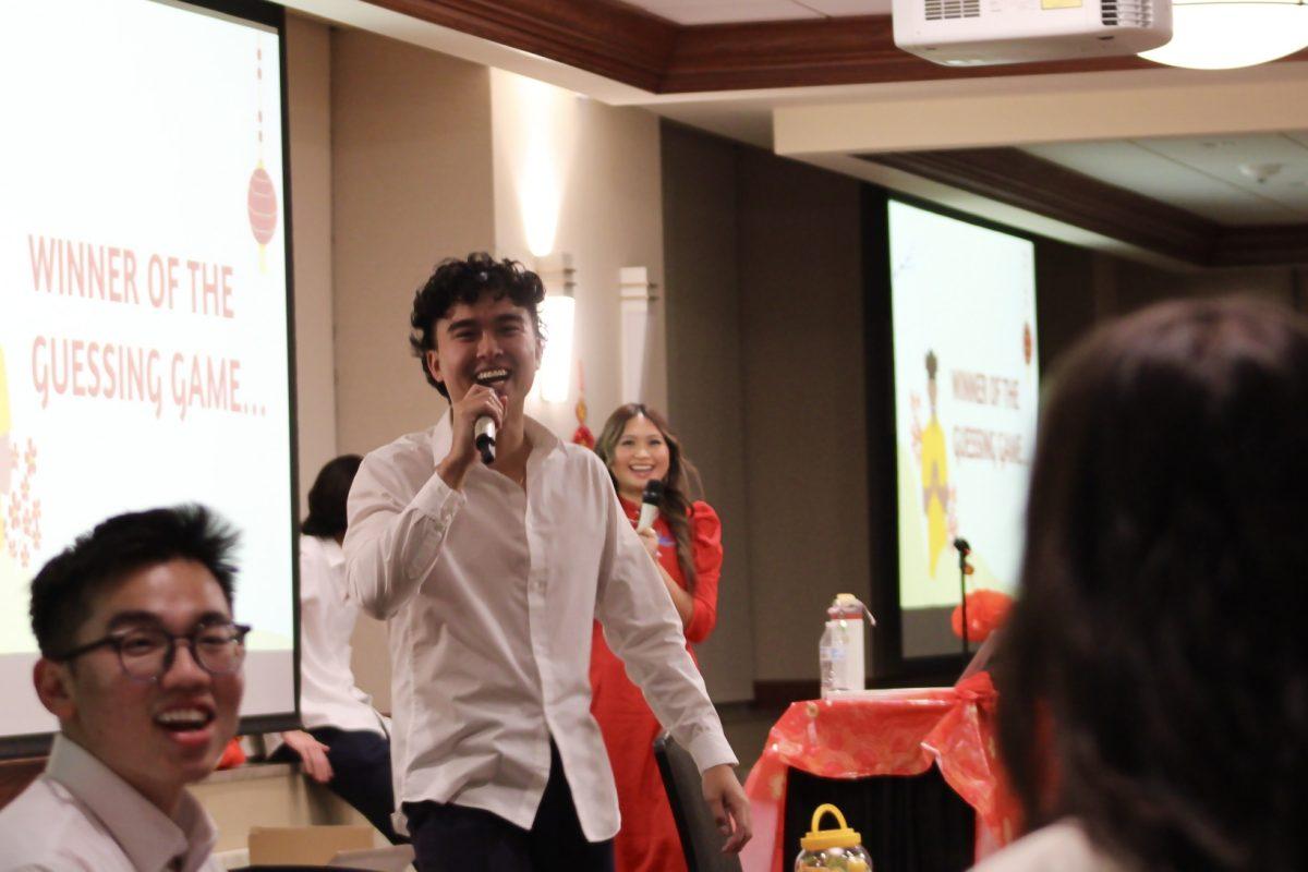 Senior Toan Vu announces the winner of a guessing game.