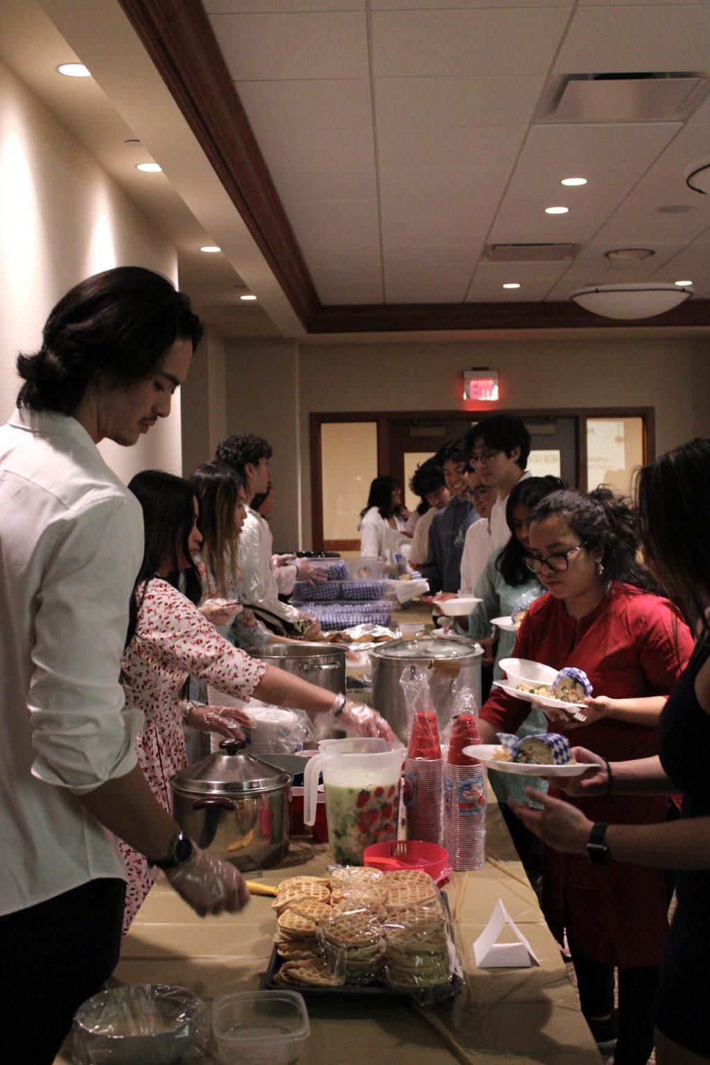 VSA executive board serves food to students.