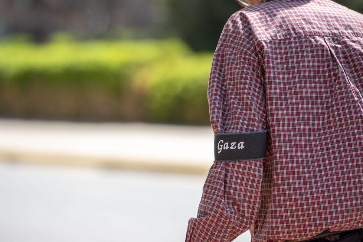 A arm with a black armband with the word “Gaza” embroidered on it.