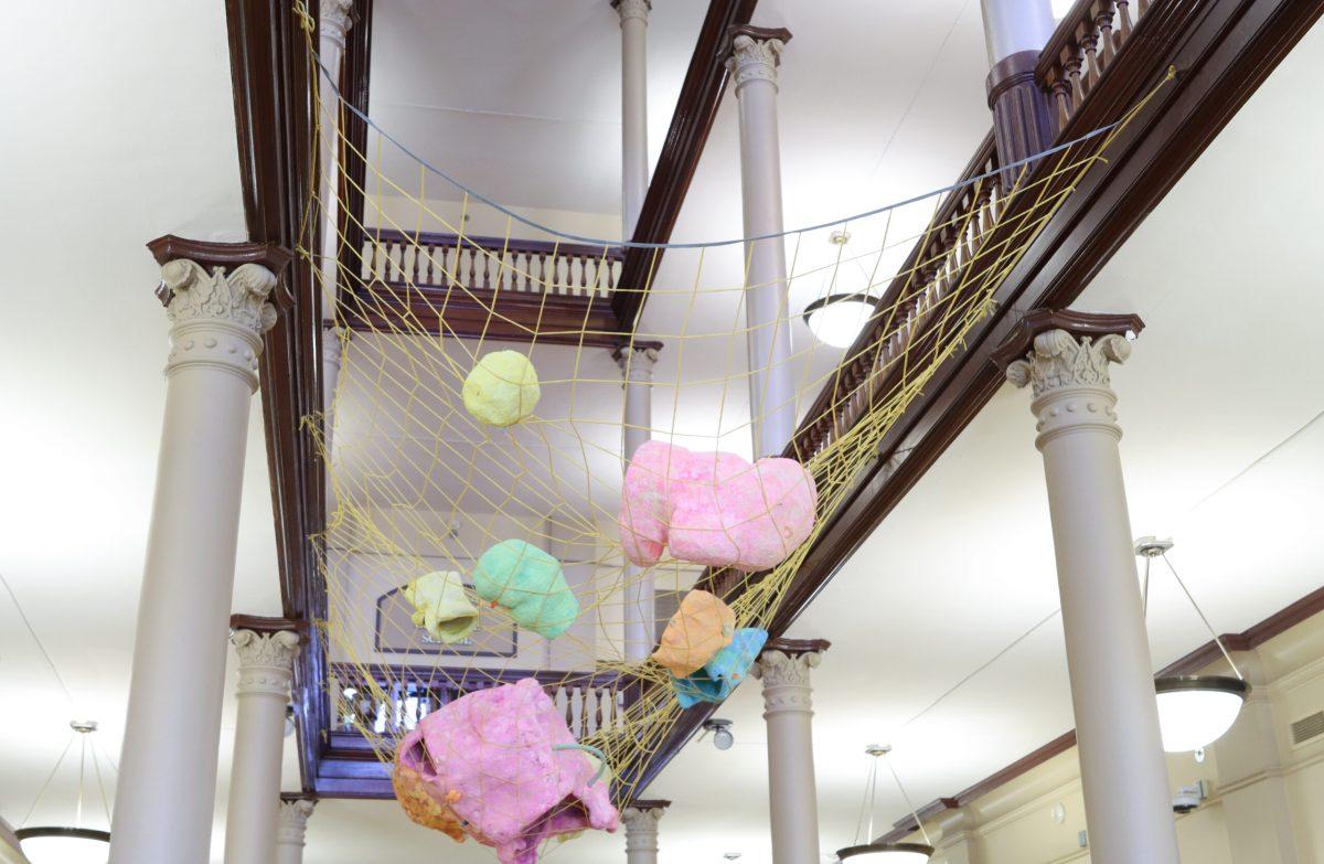 A net hangs with objects in it over the first floor of Jesse Hall.