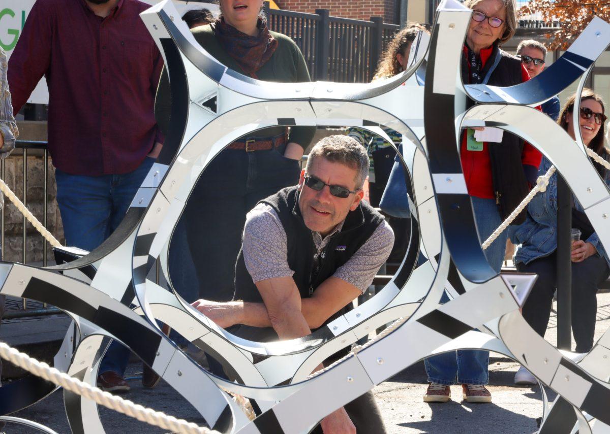 Man looks through the “World View” in the Sculpture Yard.