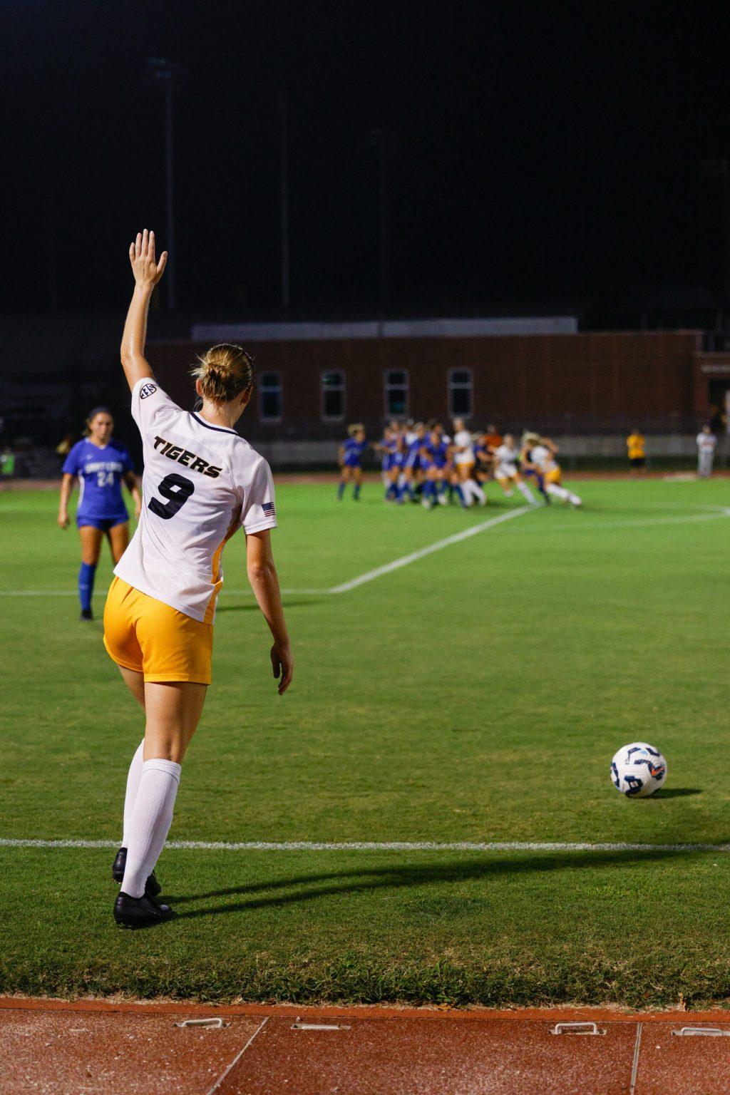 Missouri senior midfielder signaling to her teammates before taking a free
kick.