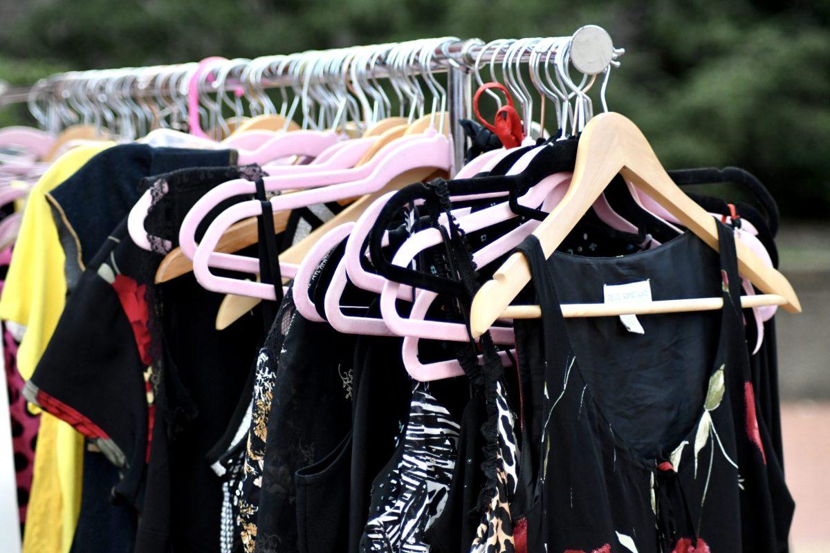A variety of garments hanging on a clothing rack.