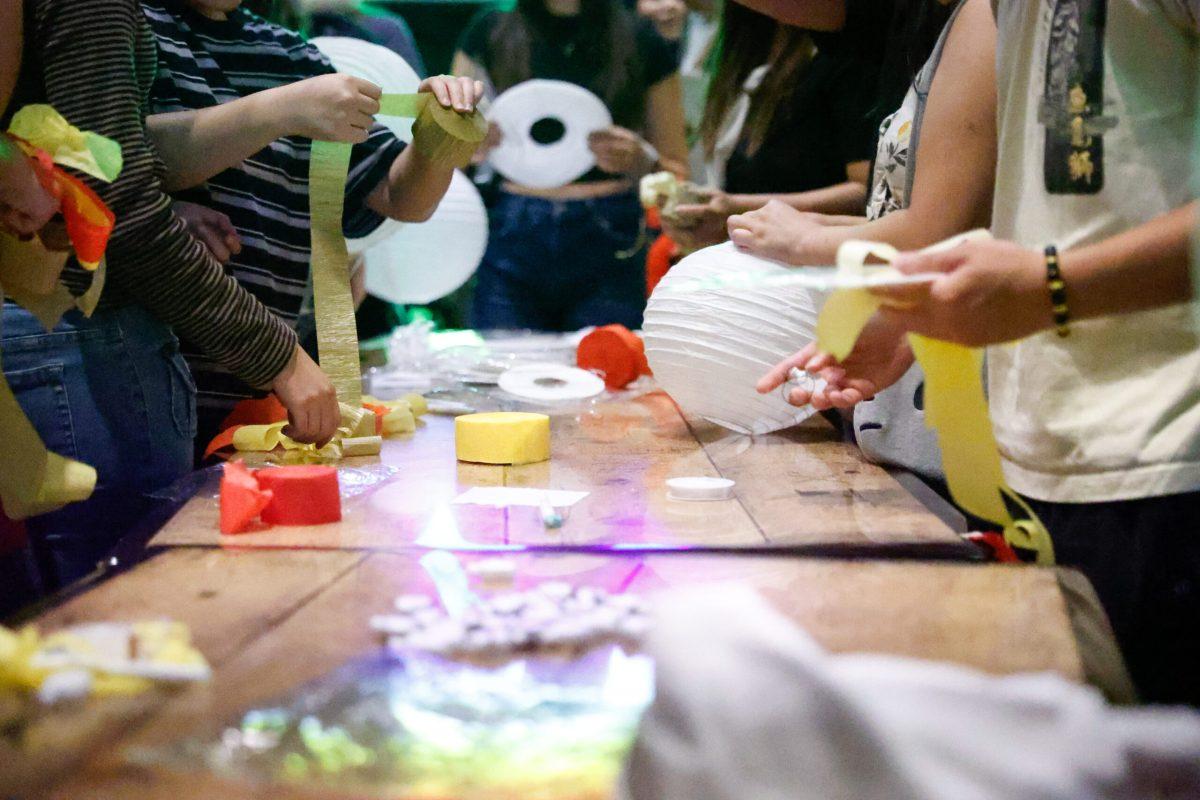 Students grabbing materials for lantern-making.