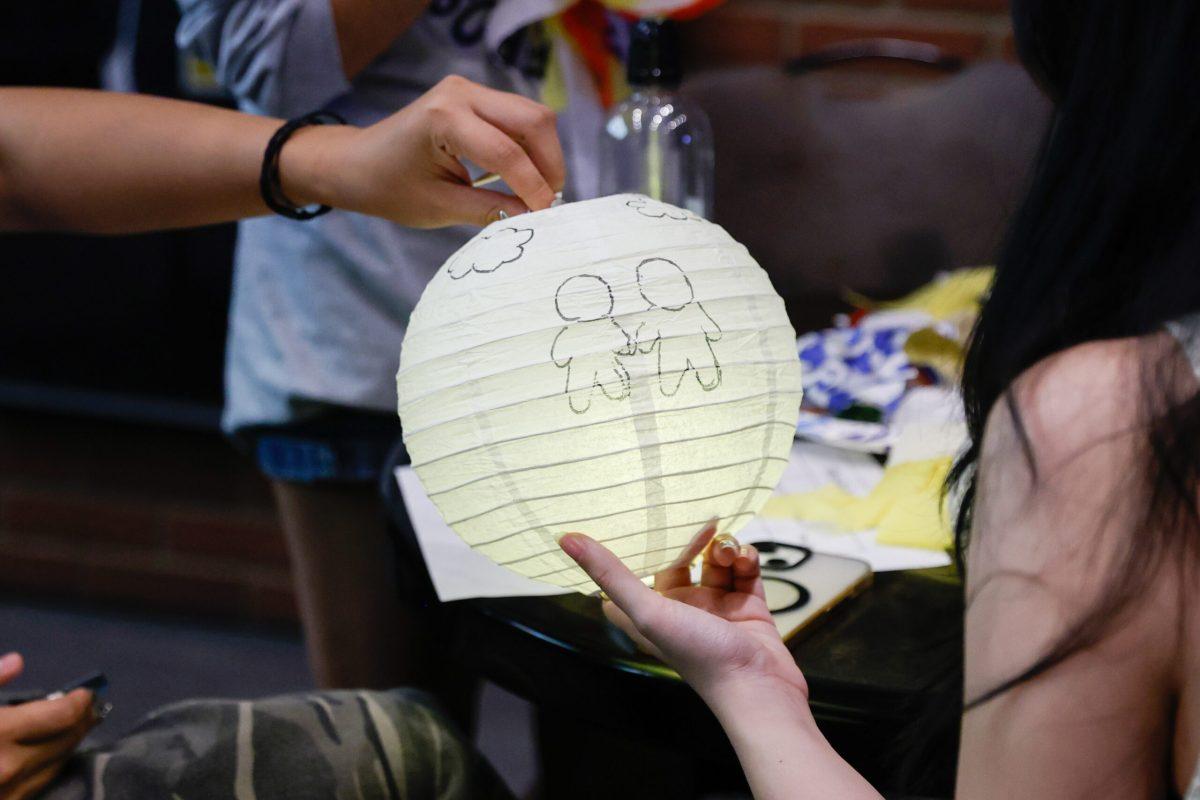 Two students holding a lantern.