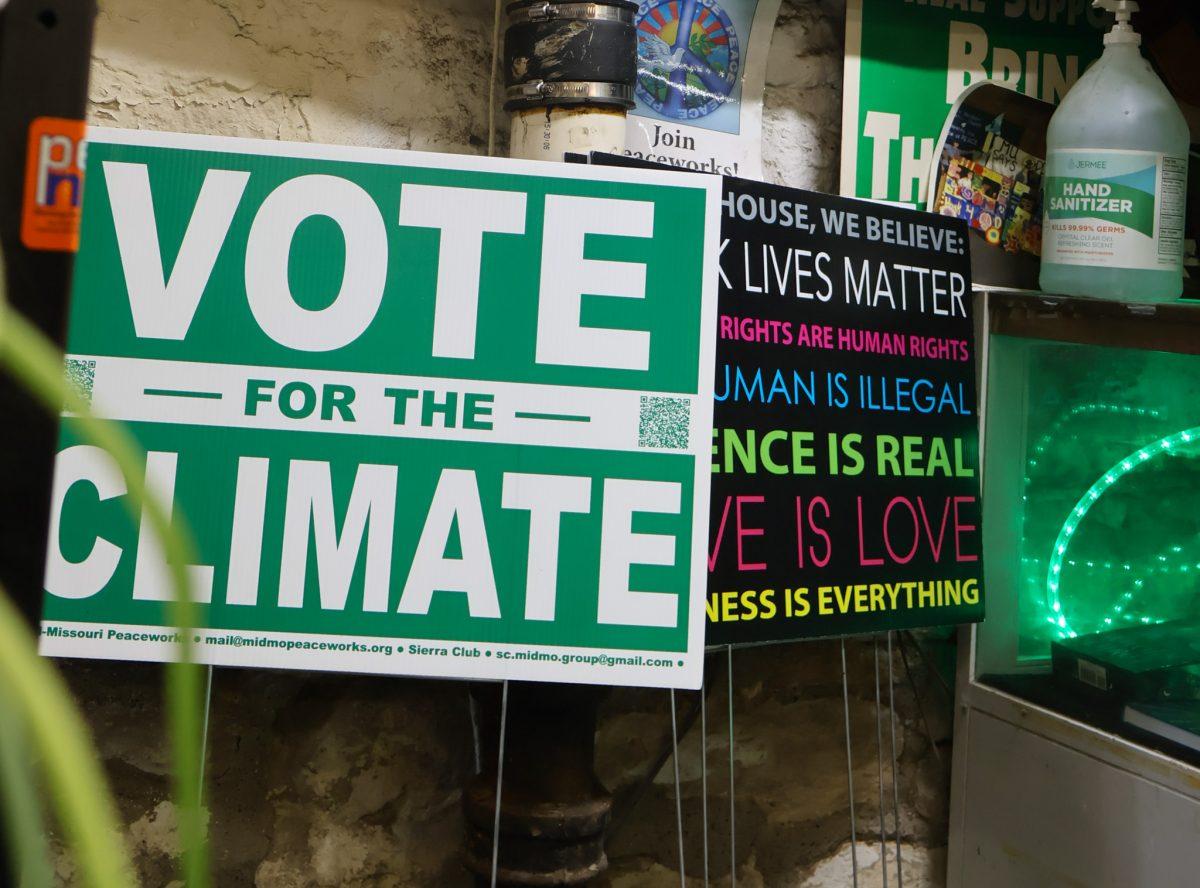 A Vote for the Climate poster lies in front of the stairs.