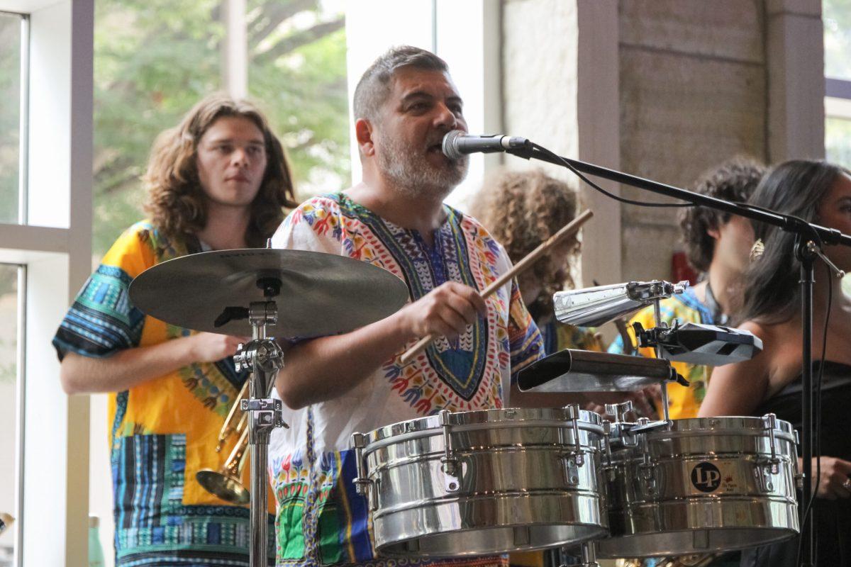 A man singing and playing instruments.