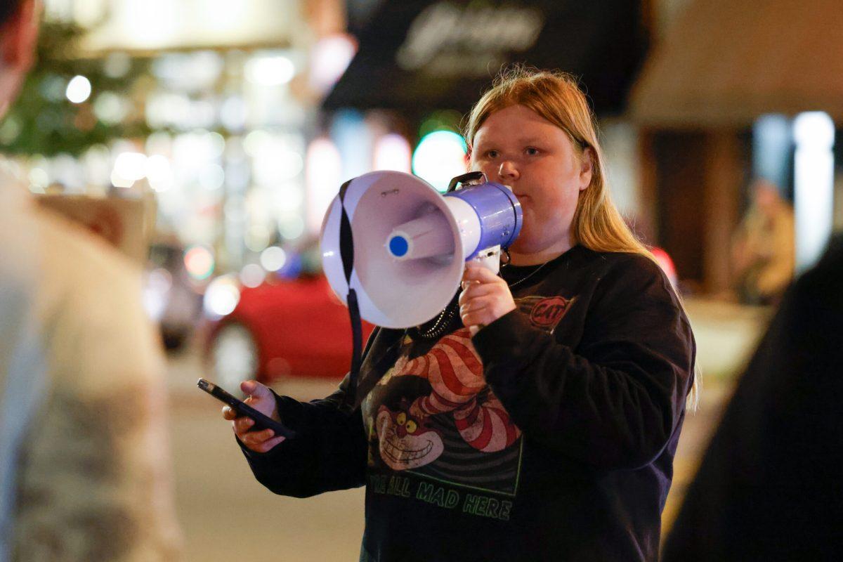A protester speaking into a megaphone.
