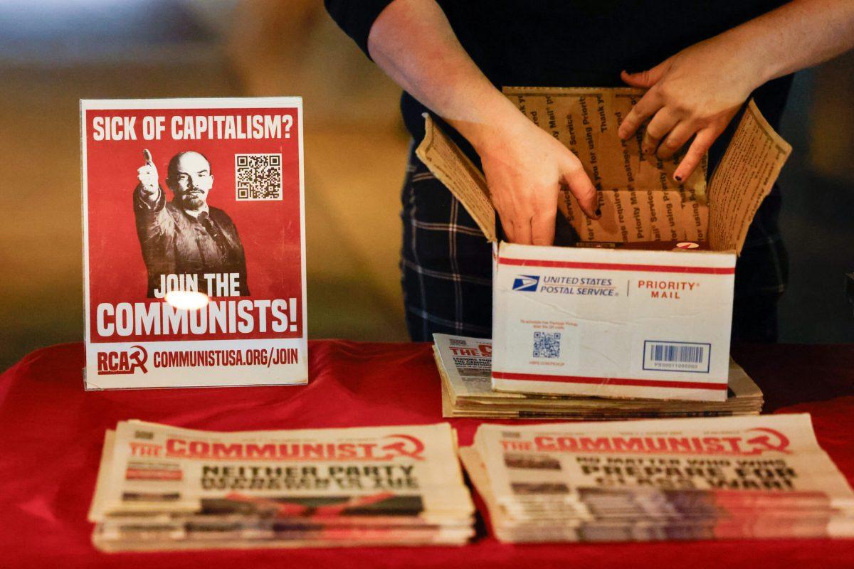 A protester laying out pamphlets on a table.