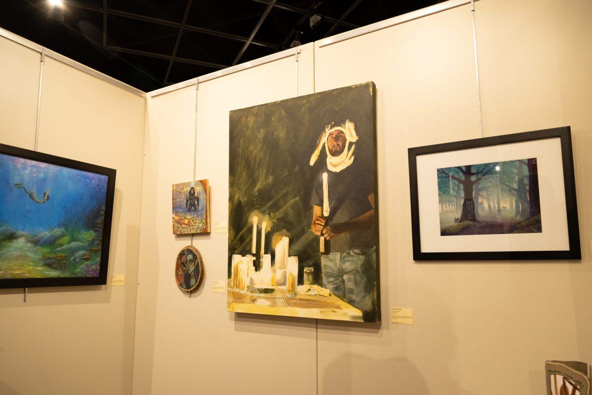 Several paintings hanging on a wall.